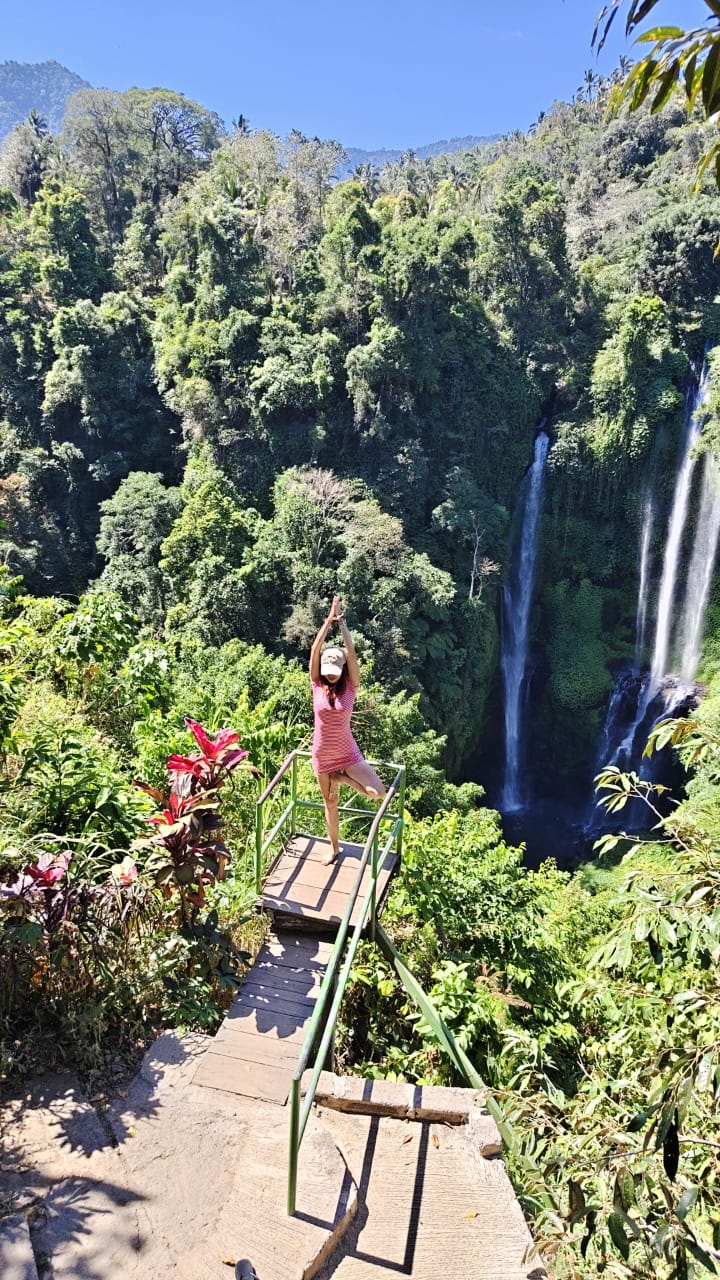 Guest posing above Sekumpul waterfall jungle